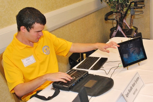 Founder of VI Tech Tutor demonstrating a Braille Note Apex as part of a “New Visions Showcase” at a NC Reading Service Gala.
